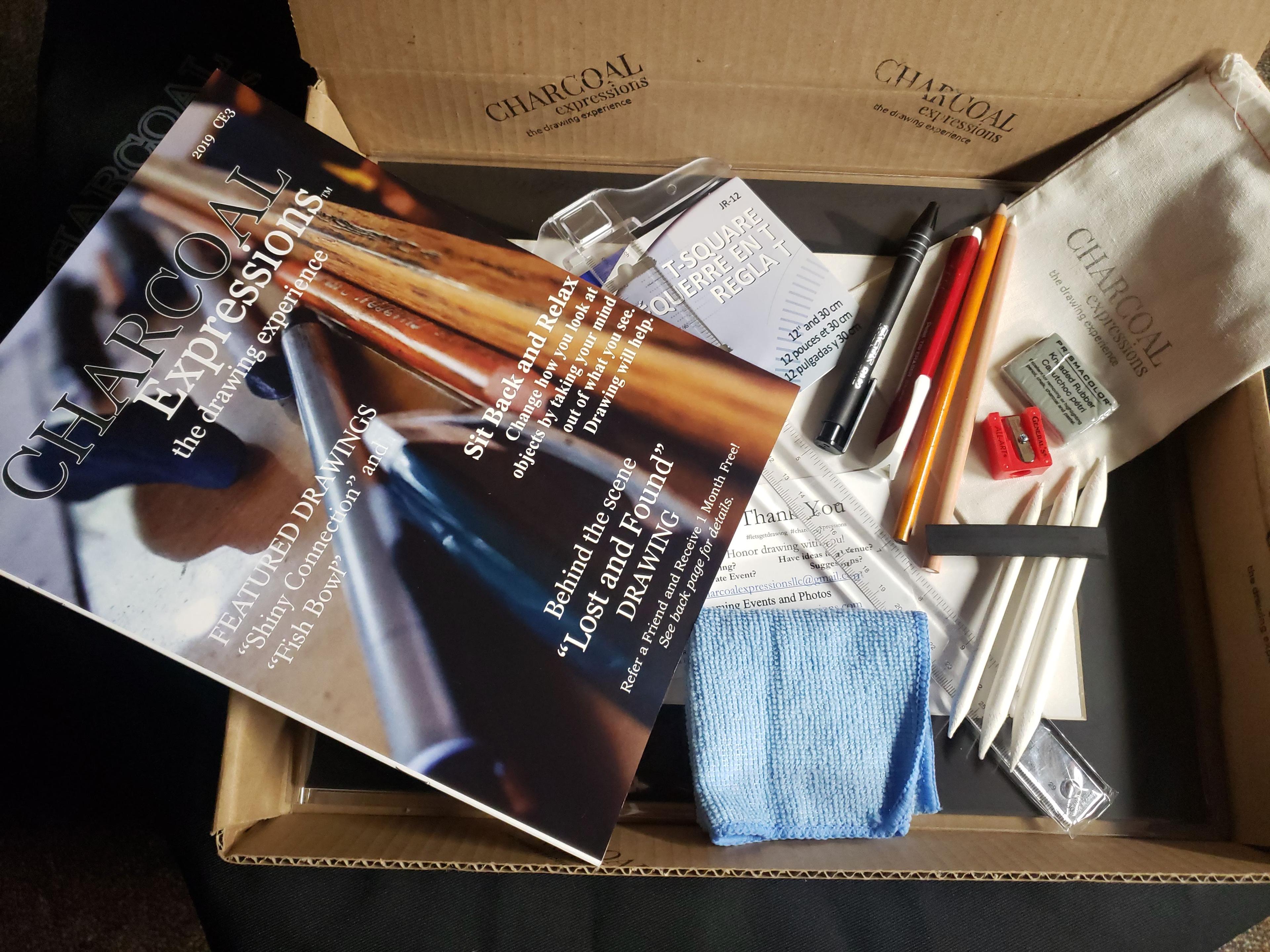 Charcoal Expressions box opened showing catalog, supplies, and drawing materials