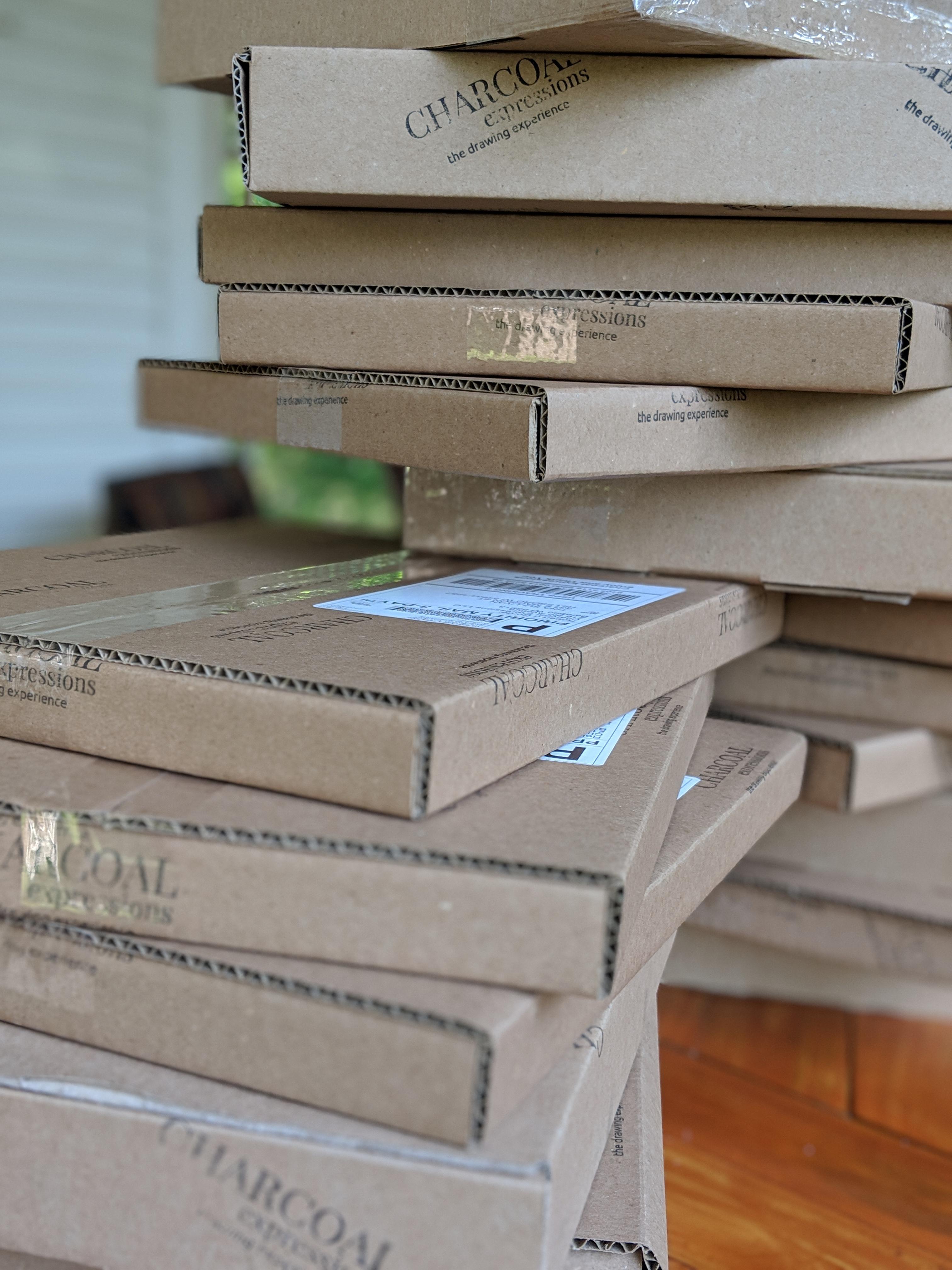 Stack of Charcoal Expressions subscription boxes ready to ship